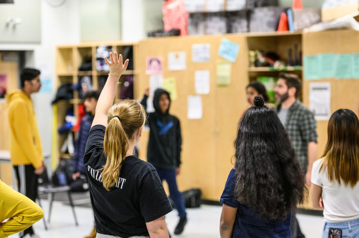 A student raises their hand in an IN CLASS Workshop. Photo by Dahlia Katz