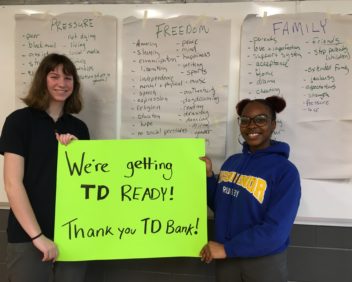 IN CLASS Students hold up a sign thanking TD for their support